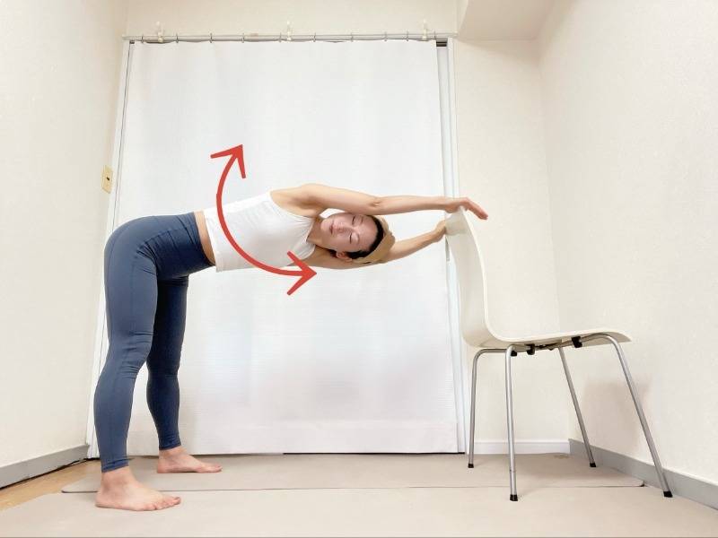 椅子の背もたれに手を置き、背中を伸ばしたまま、上半身を左右に捻るストレッチ