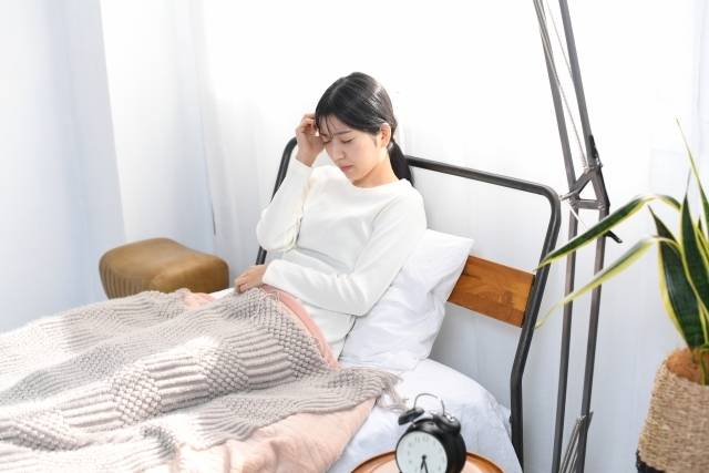 体調不良の女性