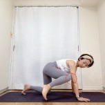 四つ這いから左膝を90度に曲げ、左肘へ寄せ、視線を左膝に向けて脇腹を縮めるエクササイズ