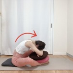 脚の上にクッションを置いて軽減したバタフライポーズ