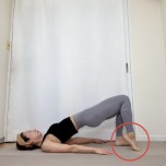 両膝を曲げた仰向けでお尻を持ち上げた橋のポーズから片方のかかとを浮かせた体勢