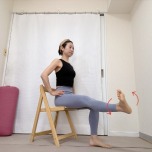 椅子に座り、左脚をゆかと並行に伸ばして足首を回すエクササイズ