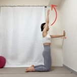 壁に向かって膝立ちになり、片手を天井方向に上げた体勢